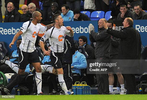 Bolton Wanderers' English defender Gary Cahill celebrates scoring his goal with team-mate Zat Knight and manager Gary Megson during the English...