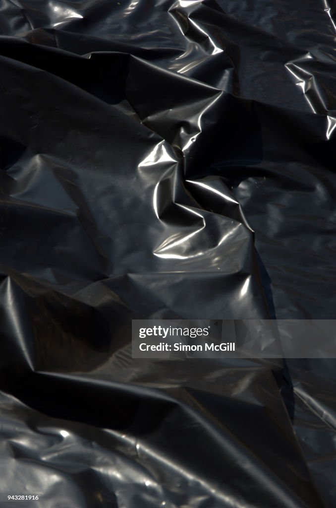 Wrinkled black plastic sheeting