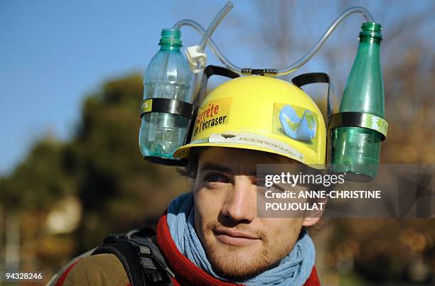 Man wears a helmet with water bottles on December 12, 2009 in Marseille, southern France, during a demonstration called by a local association...