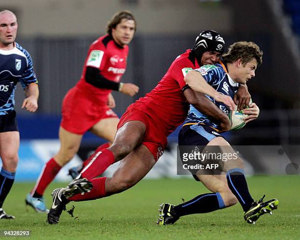 Cardiff Blues' Ben Blair is tackled by Toulouse's Thierry Dusautoir in the Heineken Cup Rugby Union match at the Cardiff City Stadium on December 12,...