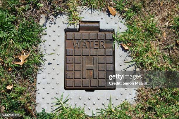 a water hydrant, inset into the ground, to be used by fire fighters to access the water supply in the case of a fire - inset stock pictures, royalty-free photos & images