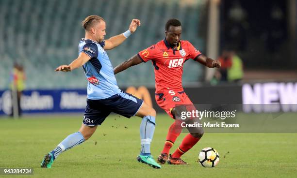 Papa Baba Diawara of Adelaide United is tackled by Jordy Buijs of Sydney FC during the round 26 A-League match between Sydney FC and Adelaide United...