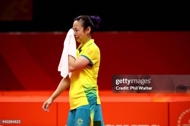Miao Miao of Australia crys after recieving a time wasting penalty in their Womens Team bronze medal match against Tin-Tin Ho of England during Table...