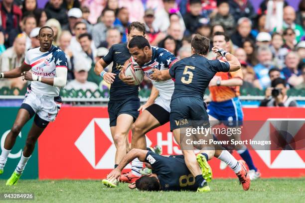 Martin Iosefo of USA is tackled by the Argentina defence during their Pool D match between USA and Argentina as part of the HSBC Hong Kong Rugby...