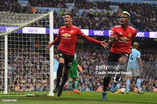 Chris Smalling of Manchester United celebrates scoring his side's third goal with Paul Pogba during the Premier League match between Manchester City...