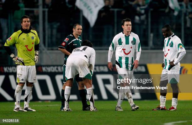 Florian Fromlowitz, Karim Haggui, Hanno Balitsch and Constant Djakpa of Hannover look dejected during the Bundesliga match between Borussia...