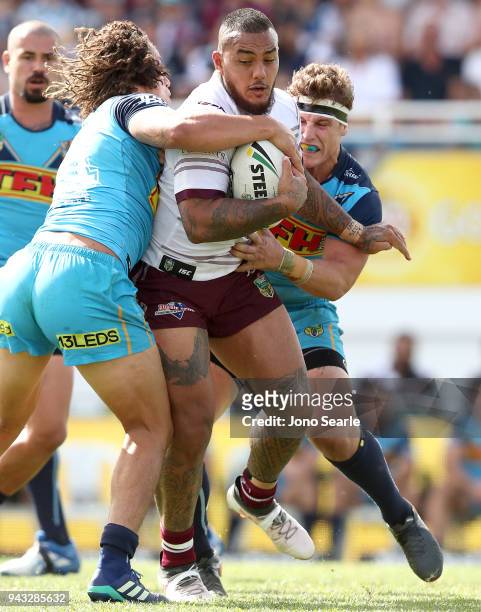 Addin Fonua-Blake of Manly is stopped by Kevin Proctor and Jarrod Wallace of the Titans during the round five NRL match between the Gold Coast Titans...