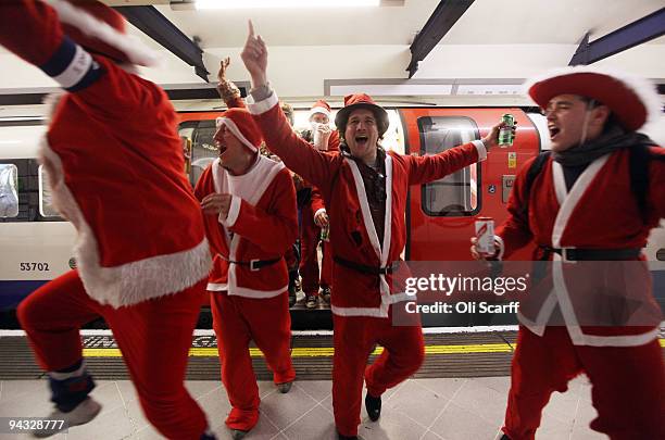 Londoners dressed in Santa Claus costumes ride the underground as they participate in 'SantaCon', a Santa-themed pub crawl across the capital on...