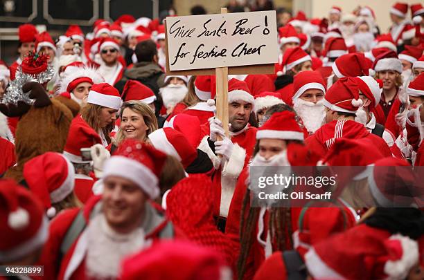 Londoners dressed in Santa Claus costumes participate in 'SantaCon', a Santa-themed pub crawl across the capital, on December 12, 2009 in London,...