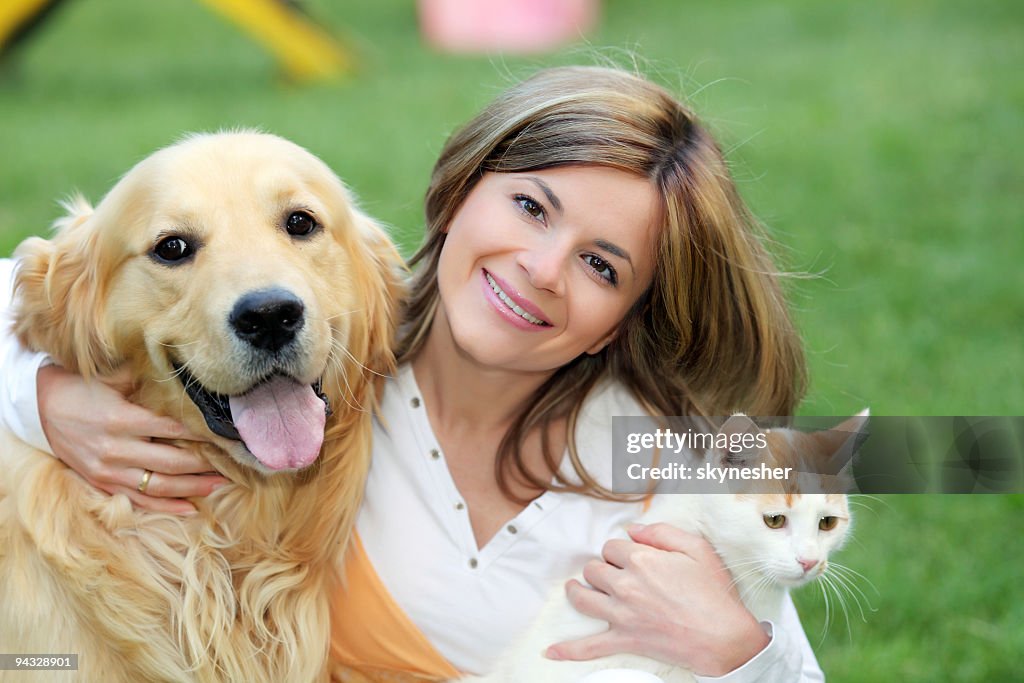 Young woman with dog and cat