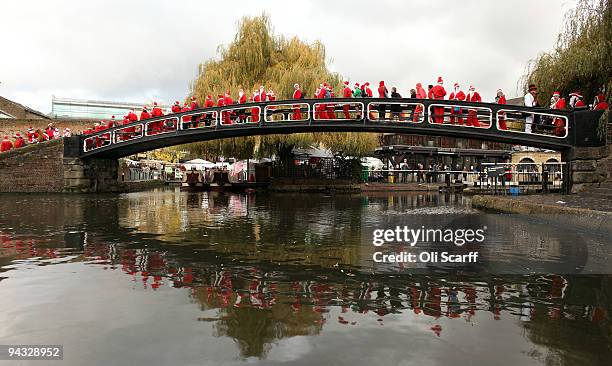 Londoners dressed in Santa Claus costumes participate in 'SantaCon', a Santa-themed pub crawl across the capital, on December 12, 2009 in London,...