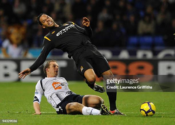 Joleon Lescott of Manchester City is fouled by Kevin Nolan of Bolton during the Barclays Premier League match between Bolton Wanderers and Manchester...