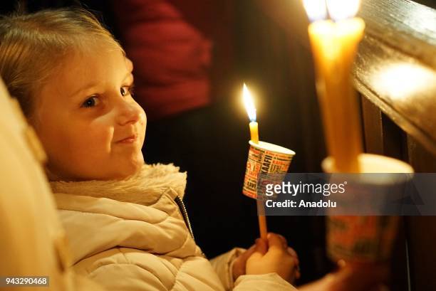 Little girl holds a candle during a mass to celebrate the Orthodox Easter at Marko's Monastery near Skopje, Macedonia on April 8, 2018. The...