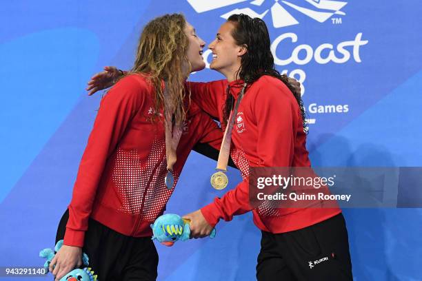 Silver medalist Taylor Ruck of Canada and gold medalist Kylie Masse of Canada embrace during the medal ceremony for the Women's 200m Backstroke Final...