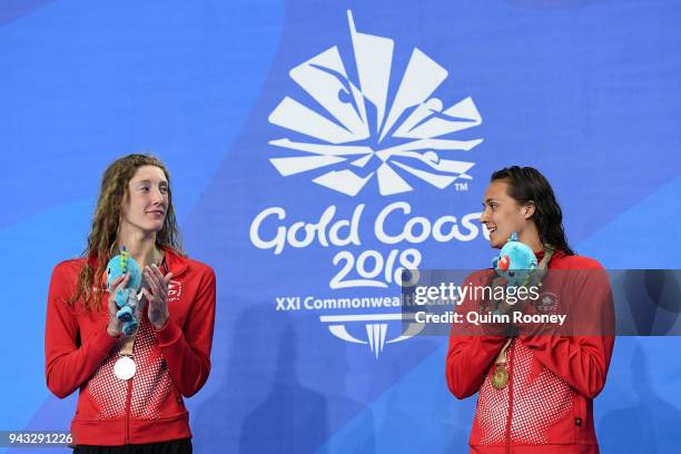 Silver medalist Taylor Ruck of Canada and gold medalist Kylie Masse of Canada look on during the medal ceremony for the Women's 200m Backstroke Final...