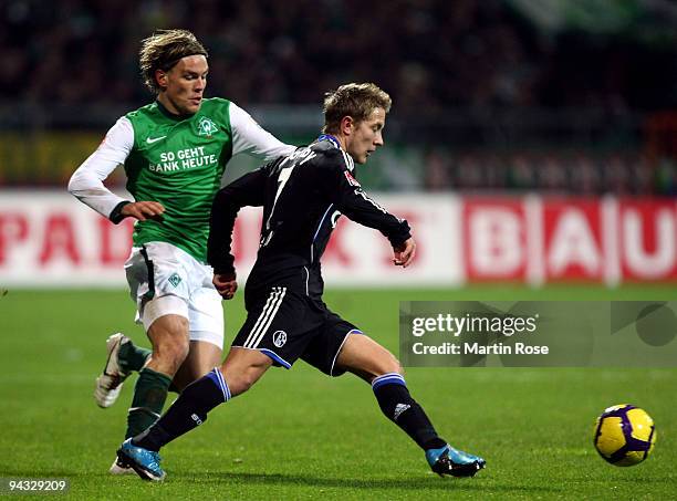 Clemens Fritz of Bremen and Lewis Holtby of Schalke compete for the ball during the Bundesliga match between Werder Bremen and FC Schalke 04 at the...