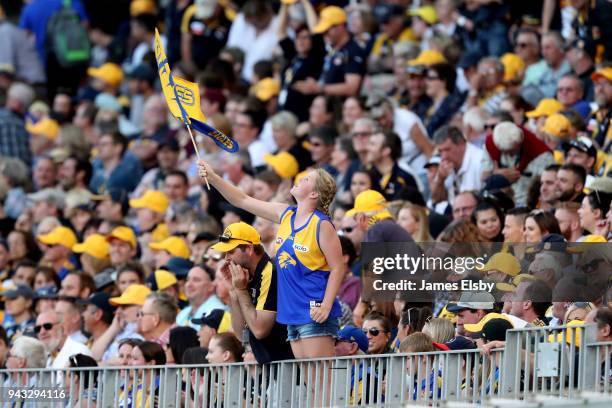 Fan cheers on the Eagles during the round three AFL match between the West Coast Eagles and the Geelong Cats at Optus Stadium on April 8, 2018 in...