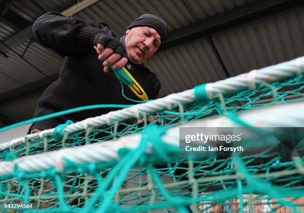 Retired fisherman mends fishing nets as fishing boats gather on the River Tyne in North Shields as fishermen take part in a nationwide protest...