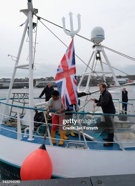 Fisherman attaches a Union Flag to his vessel as fishing boats gather on the River Tyne in North Shields as fishermen take part in a nationwide...