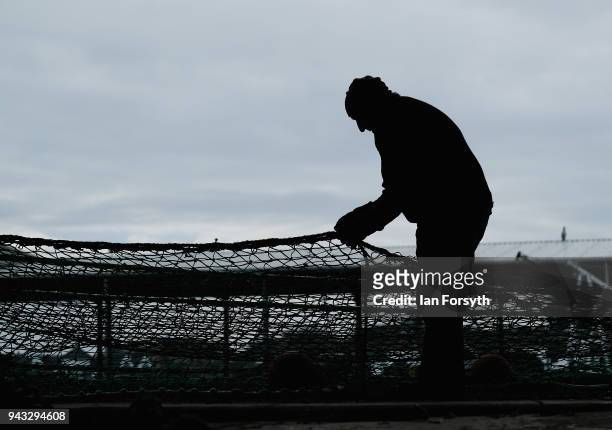 Retired fisherman mends fishing nets as fishing boats gather on the River Tyne in North Shields as fishermen take part in a nationwide protest...