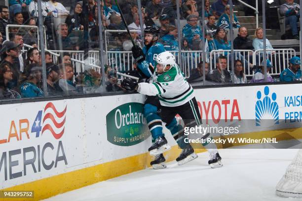 Julius Honka of the Dallas Stars checks Melker Karlsson of the San Jose Sharks into the boards at SAP Center on April 3, 2018 in San Jose,...
