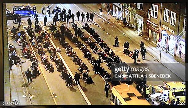 This TV grab picture shows protestors of the climate change demonstration sitting on the road in central Copenhagen on 12 December 2009. Ens of...