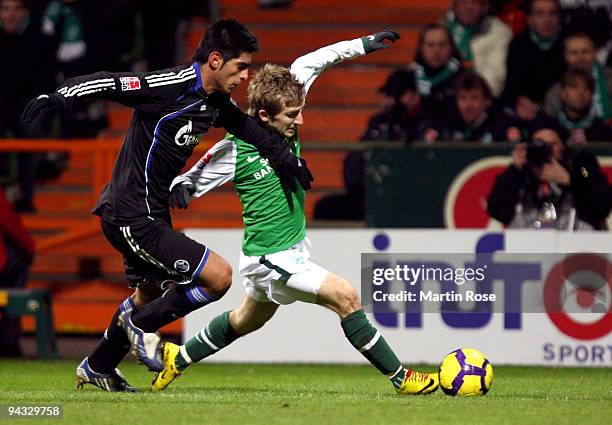 Marko Marin of Bremen and Carlos Zambrano of Schalke compete for the ball during the Bundesliga match between Werder Bremen and FC Schalke 04 at the...