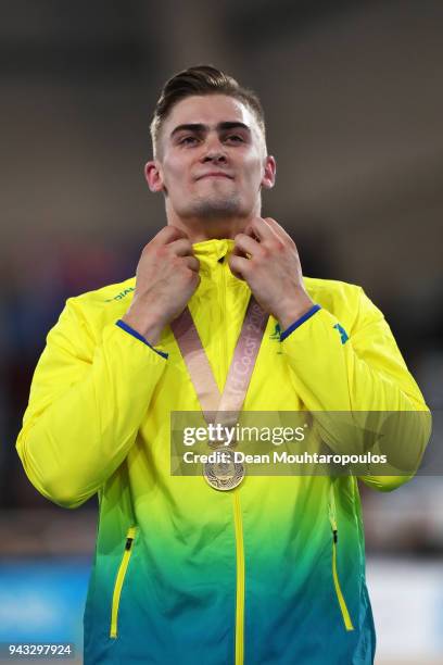 Matt Glaetzer of Australia celebrates with his gold medal on the podium after a games record time in the Men's 1000m Time Trial track cycling on day...