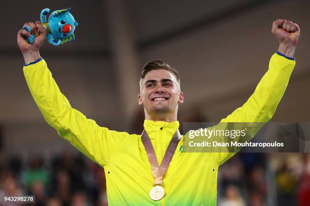 Matt Glaetzer of Australia celebrates with his gold medal on the podium after a games record time in the Men's 1000m Time Trial track cycling on day...