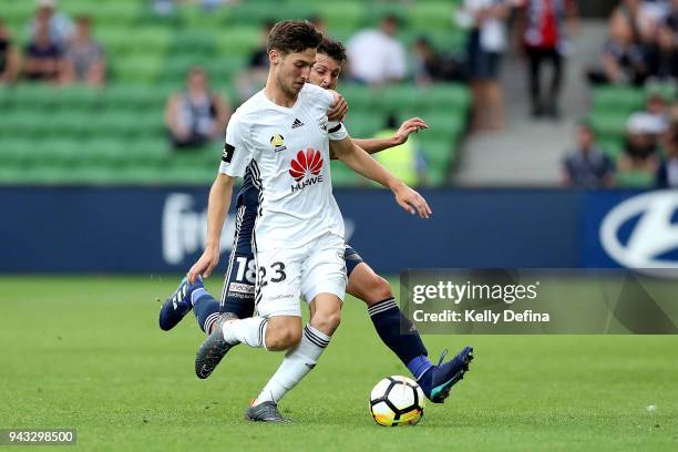 Matthew Ridenton of Wellington Phoenix and Matas Snchez of Melbourne Victory compete for the ball during the round 26 A-League match between the...