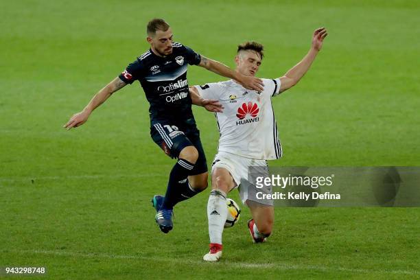 James Troisi of Melbourne Victory and Dylan Fox of Wellington Phoenix compete for the ball during the round 26 A-League match between the Melbourne...