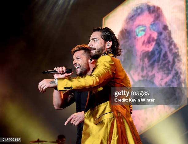 Singer Maluma , with singer Ricky Martin , performs during his "F.A.M.E. Tour" at The Forum on April 7, 2018 in Inglewood, California.