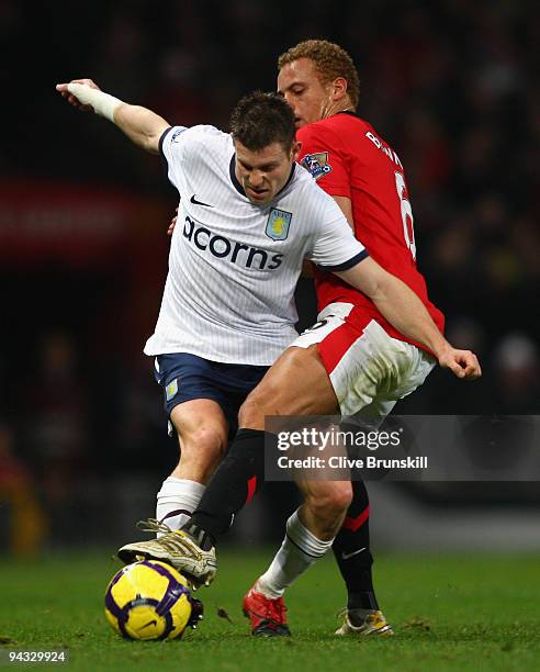 James Milner of Aston Villa tangles with Wes Brown of Manchester United during the Barclays Premier League match between Manchester United and Aston...