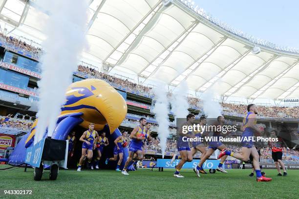 The Eagles run out to the ground during the round three AFL match between the West Coast Eagles and the Geelong Cats at Optus Stadium on April 8,...