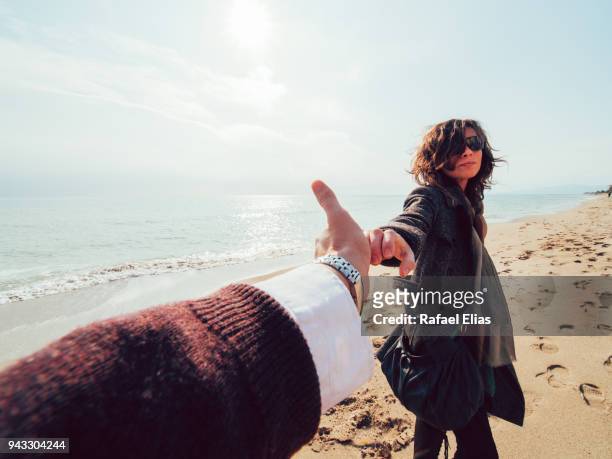 couple holding hands (pov) - costa dorada stock pictures, royalty-free photos & images