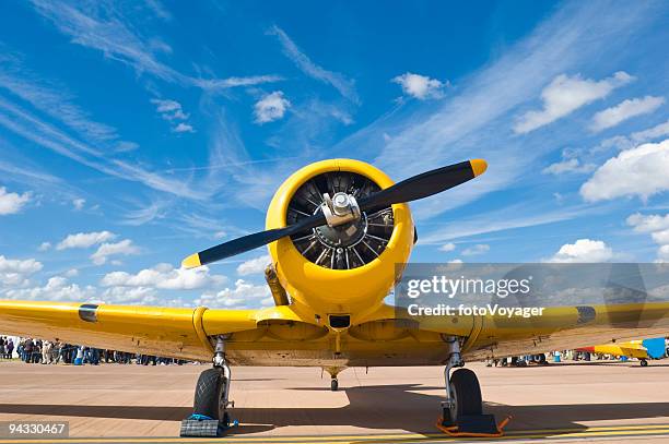 bright yellow propellor aircraft - airshow stockfoto's en -beelden