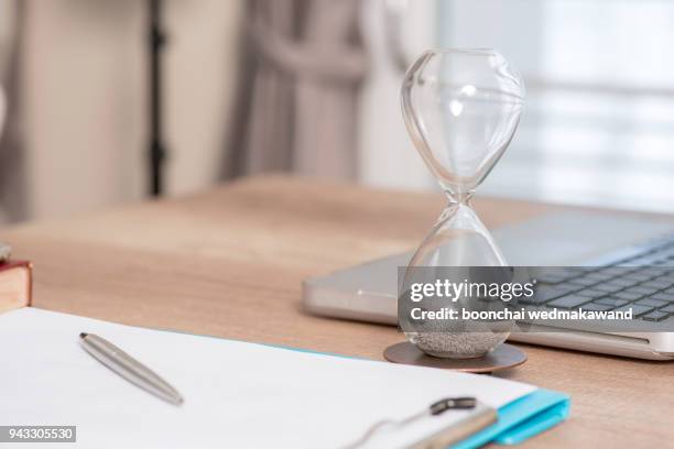 deadline and time is money concept with hourglass - 砂時計　無人 ストックフォトと画像