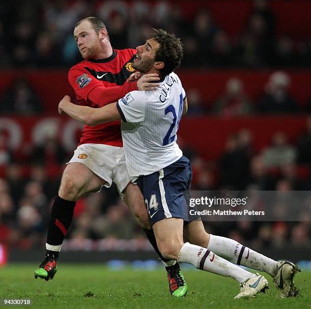 Wayne Rooney of Manchester United clashes with Carlos Cuellar of Aston Villa during the Barclays Premier League match between Manchester United and...