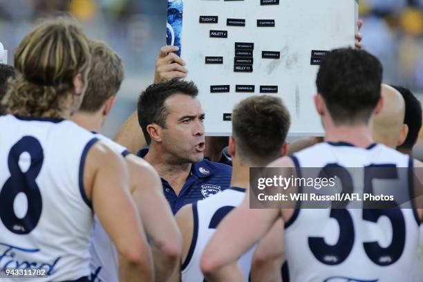 Chris Scott, Senior Coach of the Cats, addresses the players at the three-quarter time break during the round three AFL match between the West Coast...