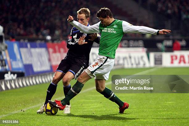 Sebastian Boenisch of Bremen and Ivan Rakitic of Schalke compete for the ball during the Bundesliga match between Werder Bremen and FC Schalke 04 at...