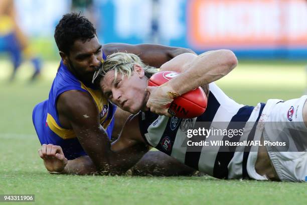 Mark Blicavs of the Cats is tackled by Liam Ryan of the Eagles during the round three AFL match between the West Coast Eagles and the Geelong Cats at...