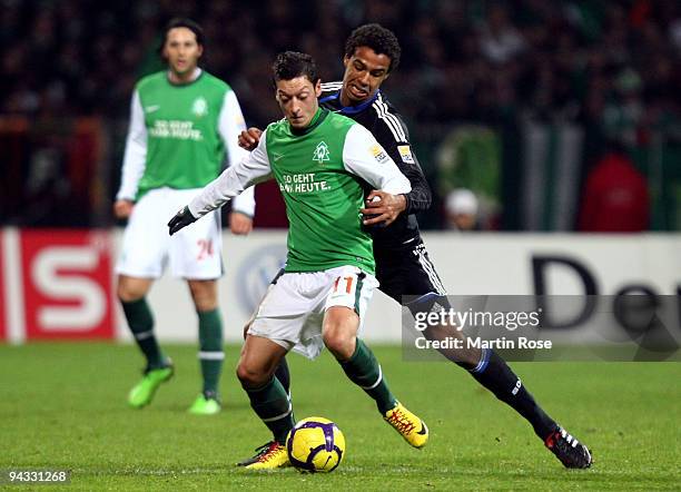 Mesut Oezil of Bremen and Joel Matip of Schalke compete for the ball during the Bundesliga match between Werder Bremen and FC Schalke 04 at the Weser...