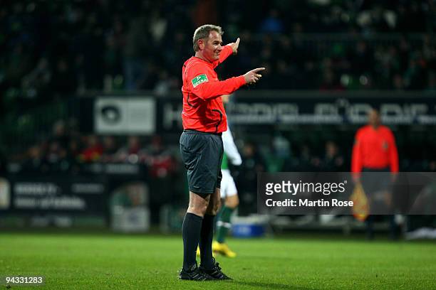 Referee Helmut Fleischer makes a point during the Bundesliga match between Werder Bremen and FC Schalke 04 at the Weser stadium on December 12, 2009...