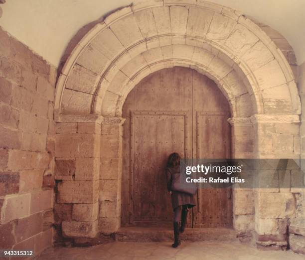 woman looking through church gate keyhole - looking through keyhole stock pictures, royalty-free photos & images