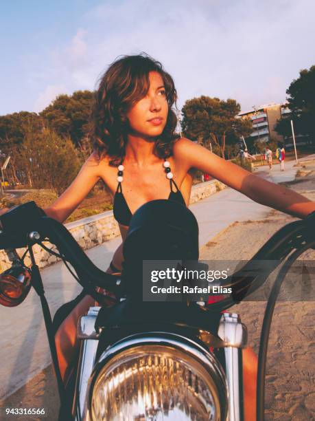 young woman on motorbike - costa dorada stock pictures, royalty-free photos & images