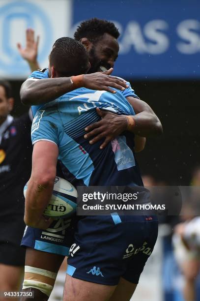 Montpellier's French flanker Louis Picamoles is congratulated by his teammate Montpellier's French flanker Fulgence Ouedraogo during the French Top...