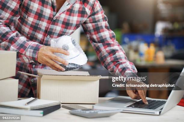 young start up small business owner packing camera cctv in the box at workplace. freelance man seller prepare product for packaging process at home. online selling, internet marketing, e-commerce concept. - electronic products stockfoto's en -beelden