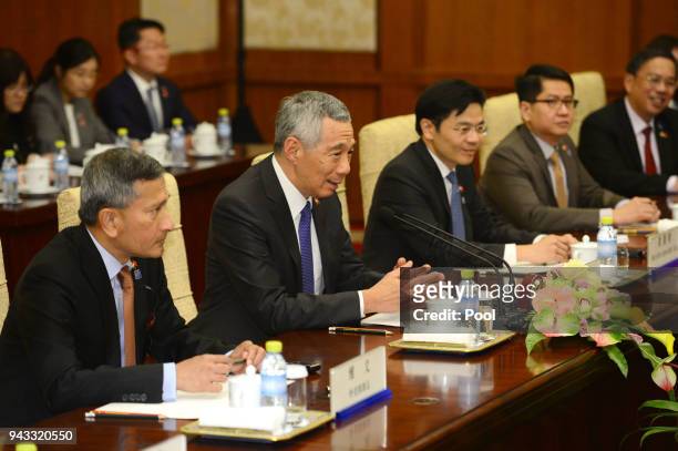 Singapore's Prime Minister Lee Hsien Loong, speaks with Chinese Premier Li Keqiang during their meeting on April 8, 2018 at the Diaoyutai State...