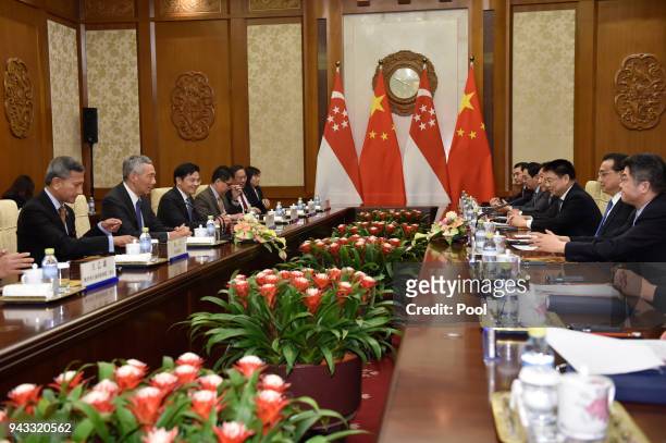 Singapore's Prime Minister Lee Hsien Loong, , talks with Chinese Premier Li Keqiang, , during their meeting on April 8, 2018 at the Diaoyutai State...