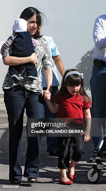 Honduran deposed President Manuel Zelaya's daughter Zoe Zelaya with her children Juan Manuel and Irene, walks towards the entrance of the Brazilian...